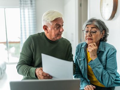 Senior couple doing financial planning at home. 