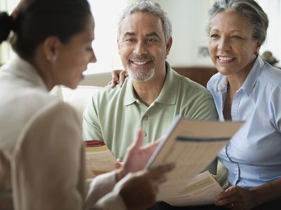 Saleswoman talking to a couple in a living room