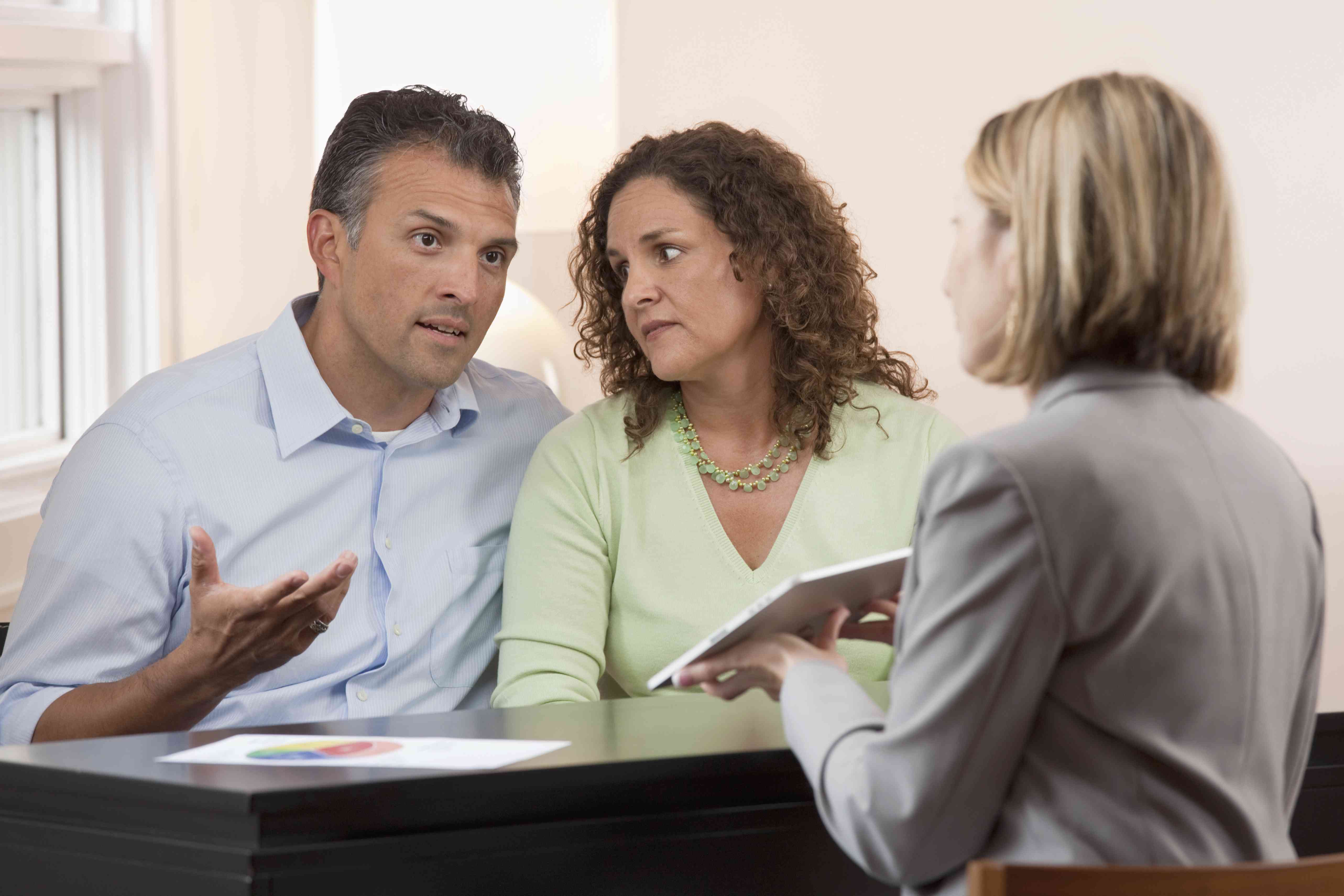 A couple having an intense discussion with their financial advisor