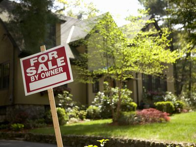 For Sale By Owner sign outside single-family home