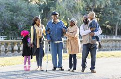 Generations of a Black family walking in park