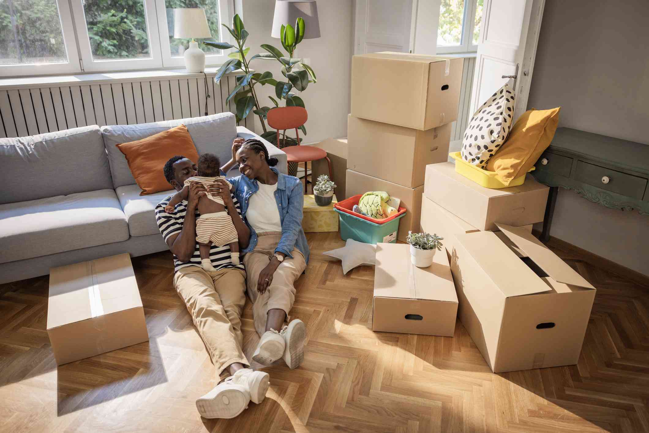 A young couple relax amid boxes.