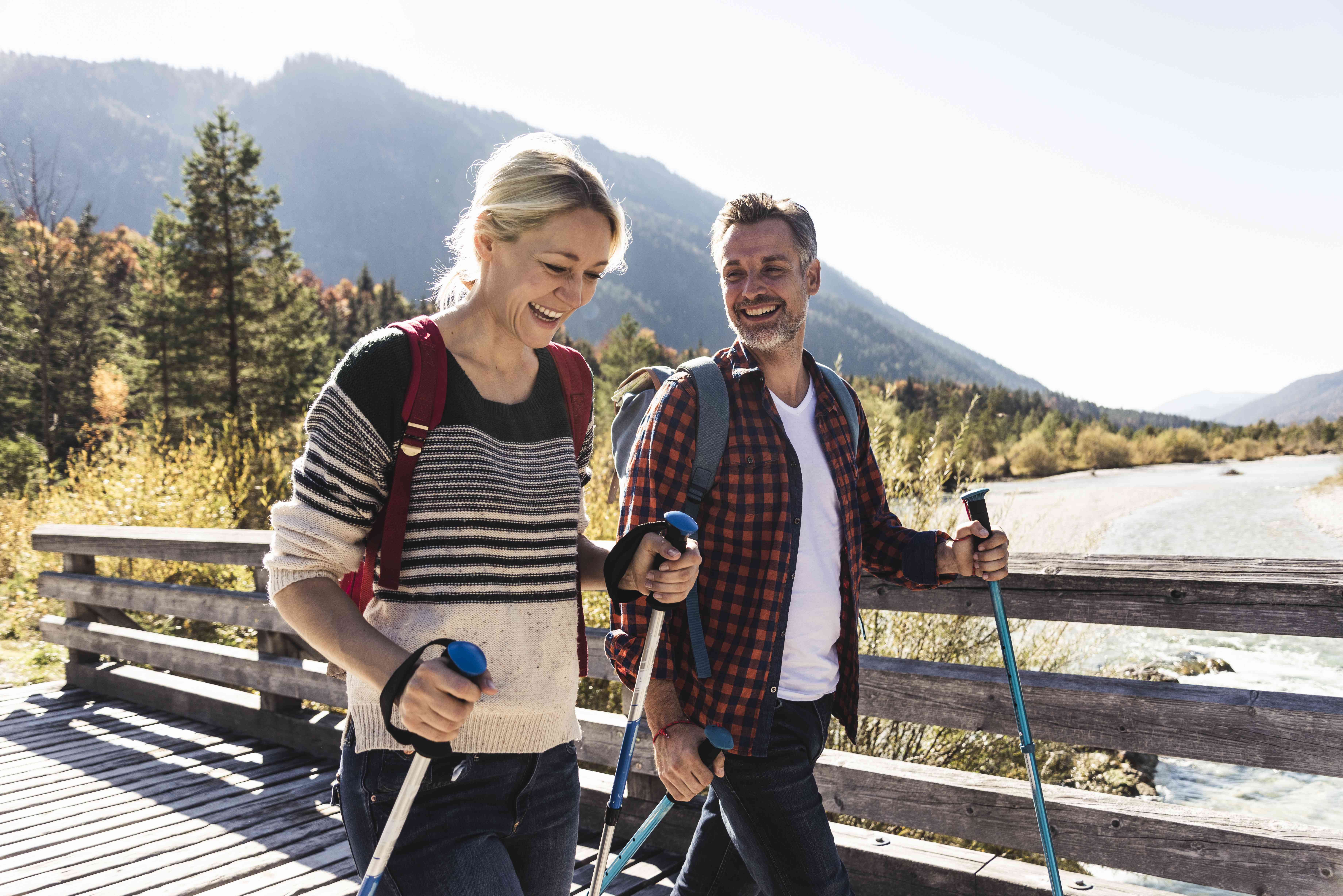 A couple takes a hike in a mountainous region.