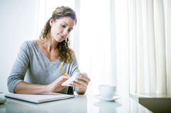 Woman calculating cost of insurance