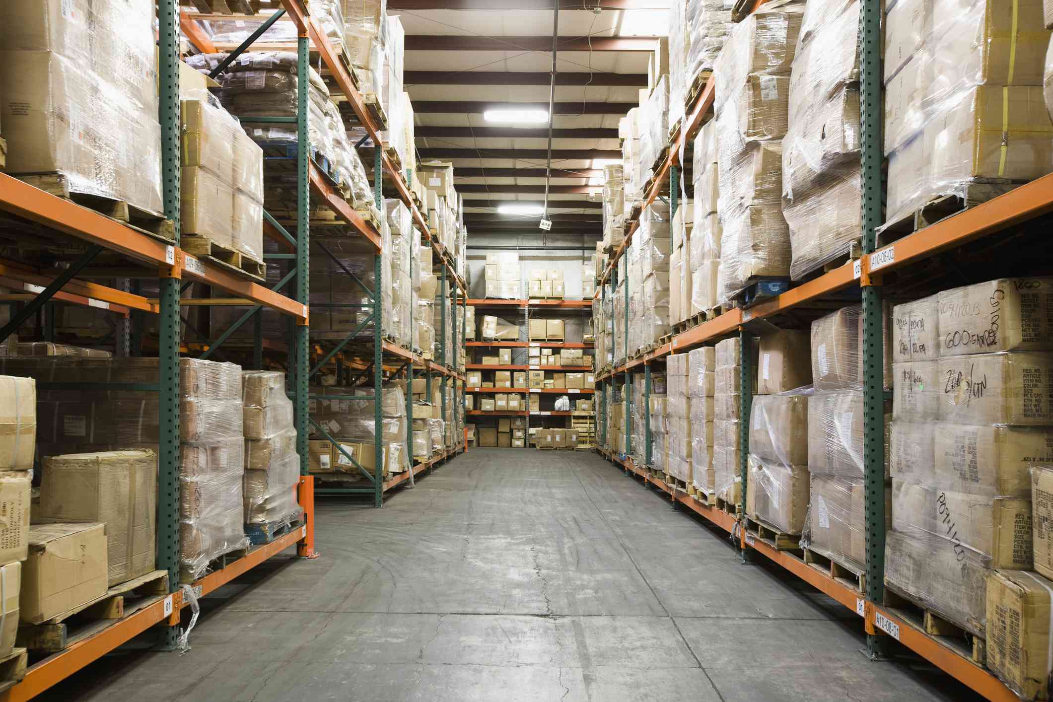 Warehouse with shelves stacked full of packing boxes