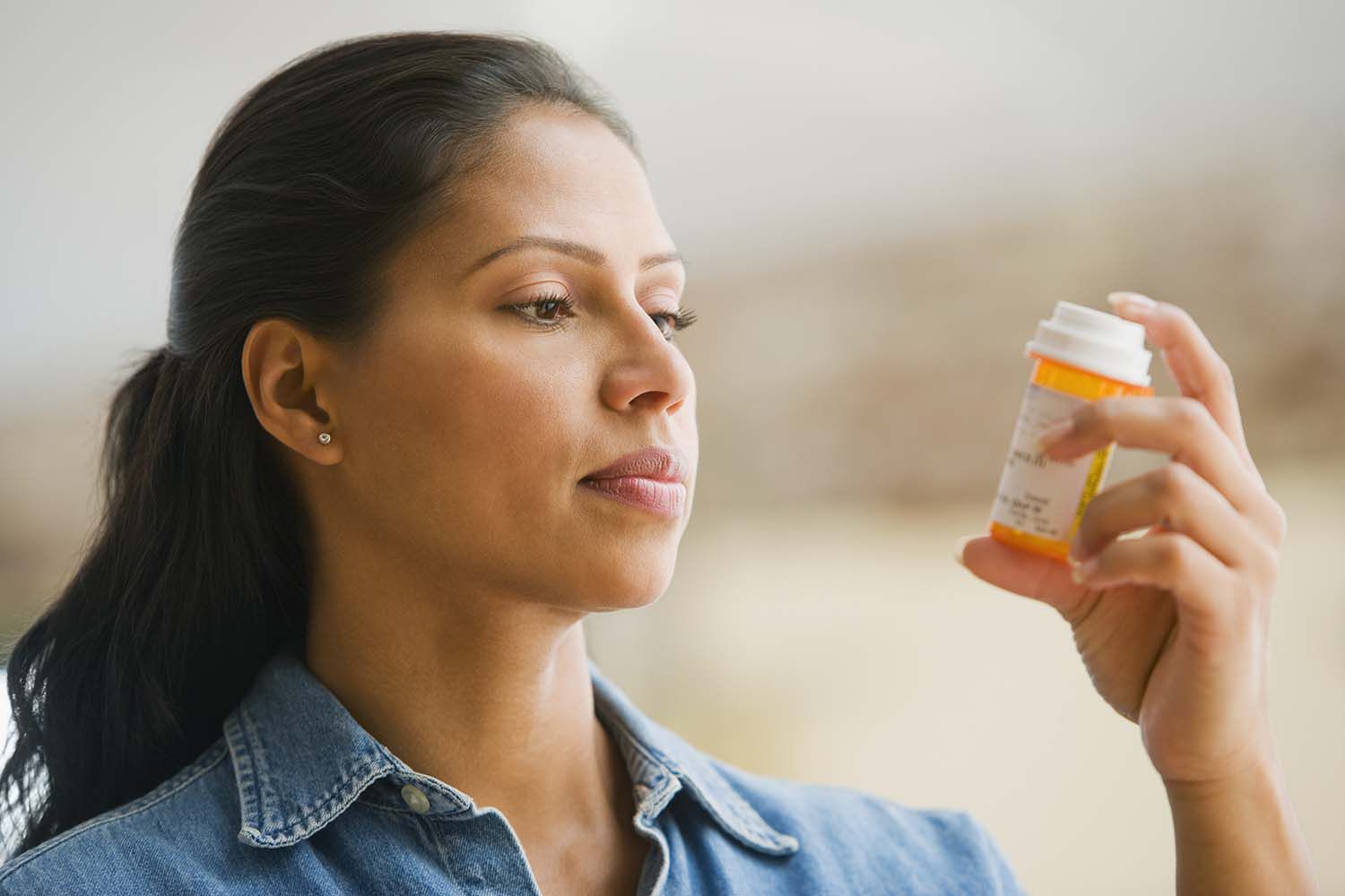 woman reading medication affordable health insurance