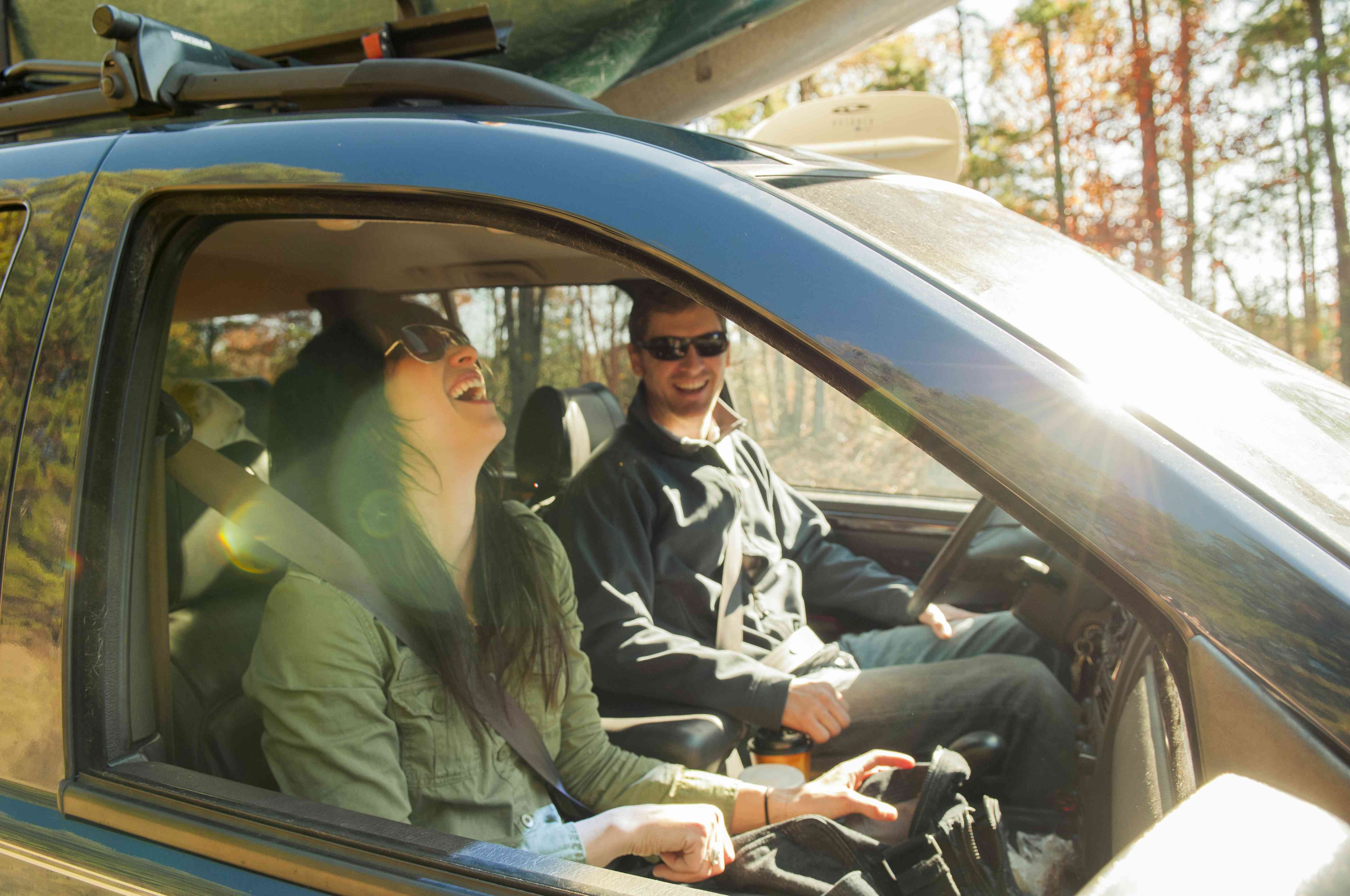 A couple rides in a car.