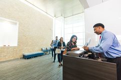 Customer receiving deposit interest at bank counter