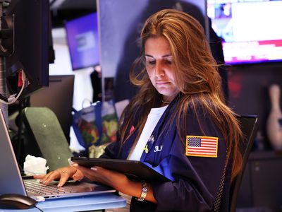 Trader on the floor of an Exchange working at her trading booth.