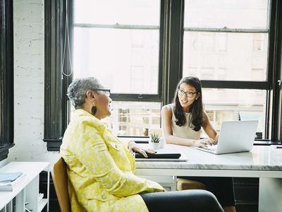 Businesswoman consulting with financial advisor in office