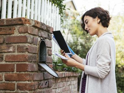 Woman checking her mailbox for her FAFSA award letter