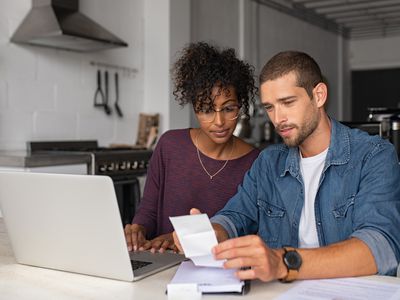 Couple looks over their finances as they consider a refi.