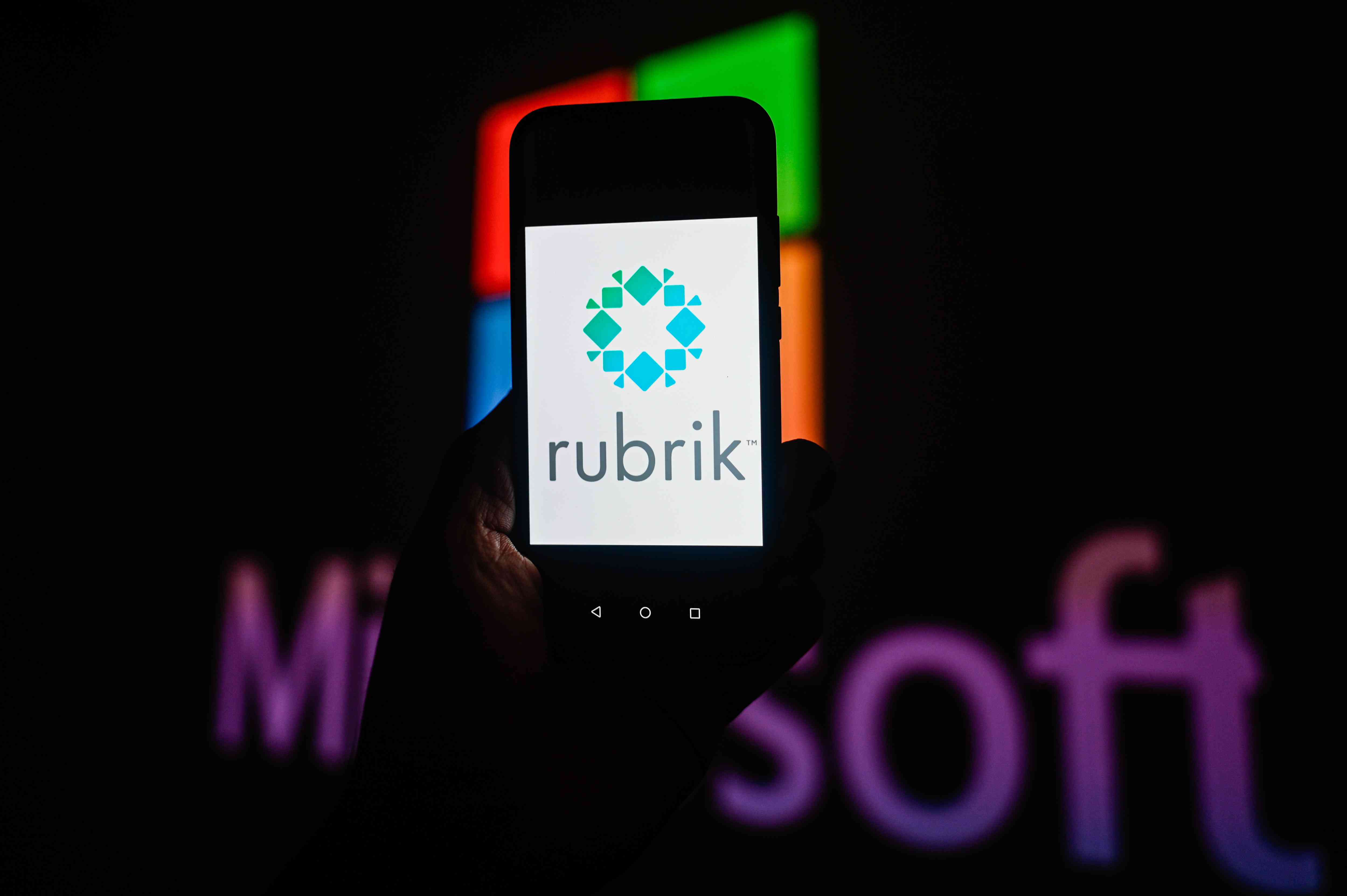 The Rubrik logo on display in front of the Microsoft logo.