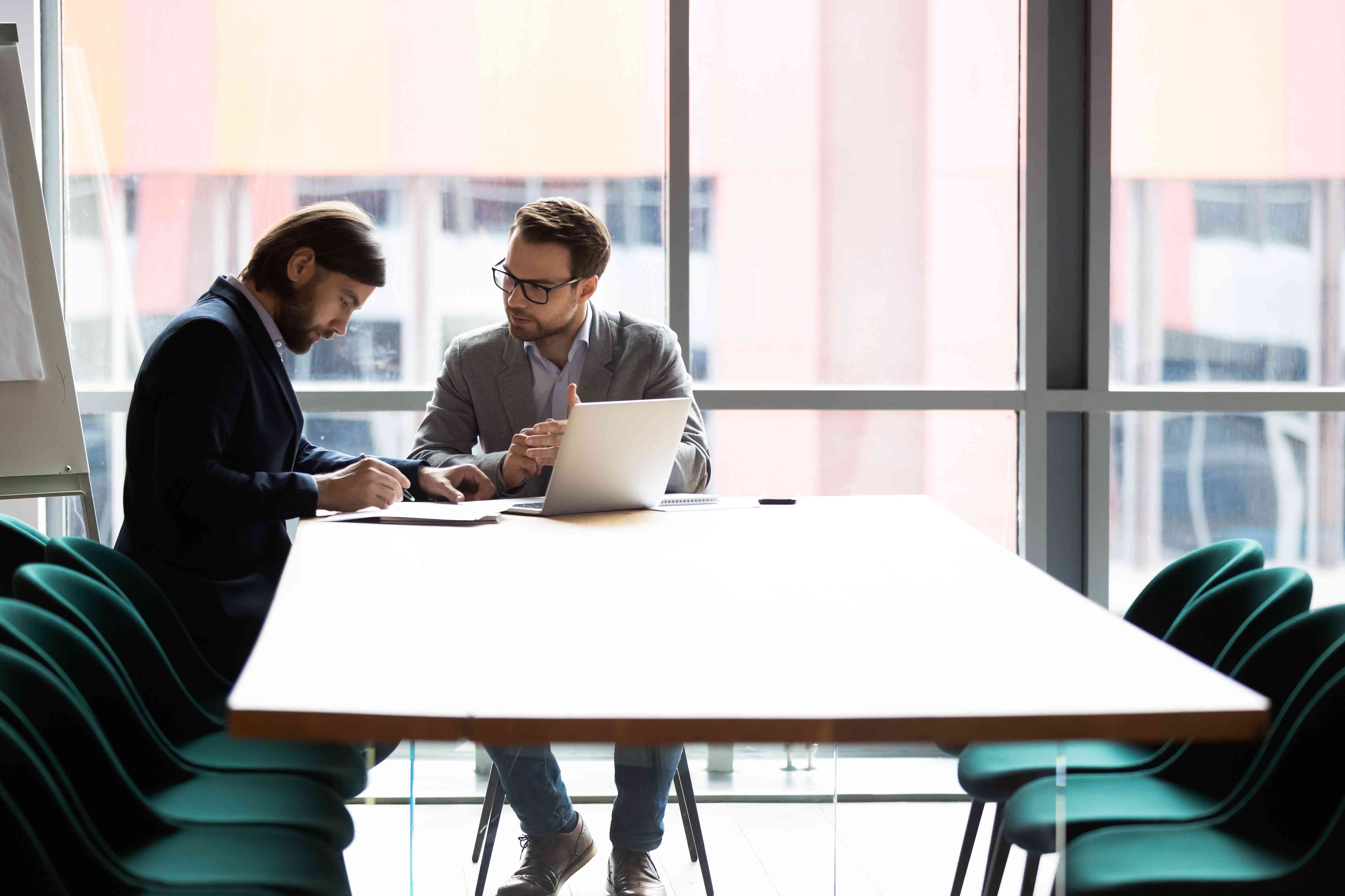 Two executives review documents.