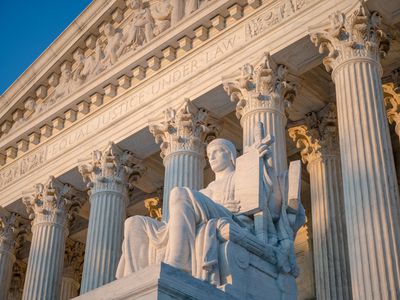 Exterior of Supreme Court of the United States on First Street in Washington DC, USA with statue by James Earle Fraser titled Authority of Law (1935)