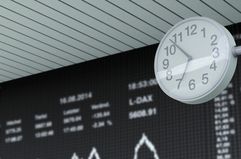 Stock exchange trading and clock in the foreground