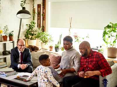 Parents with son discussing finances with advisor