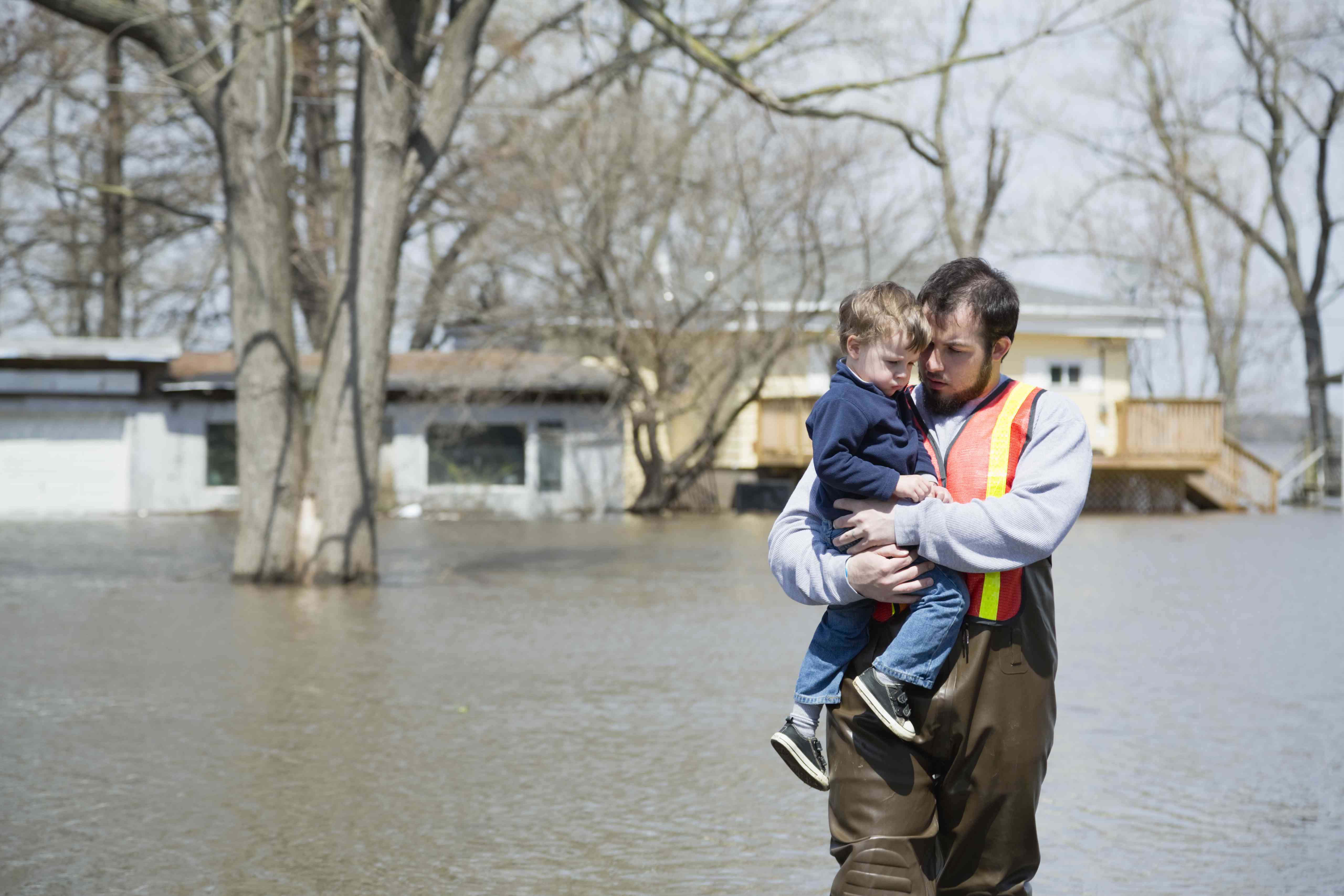 Man holding a child in the flood