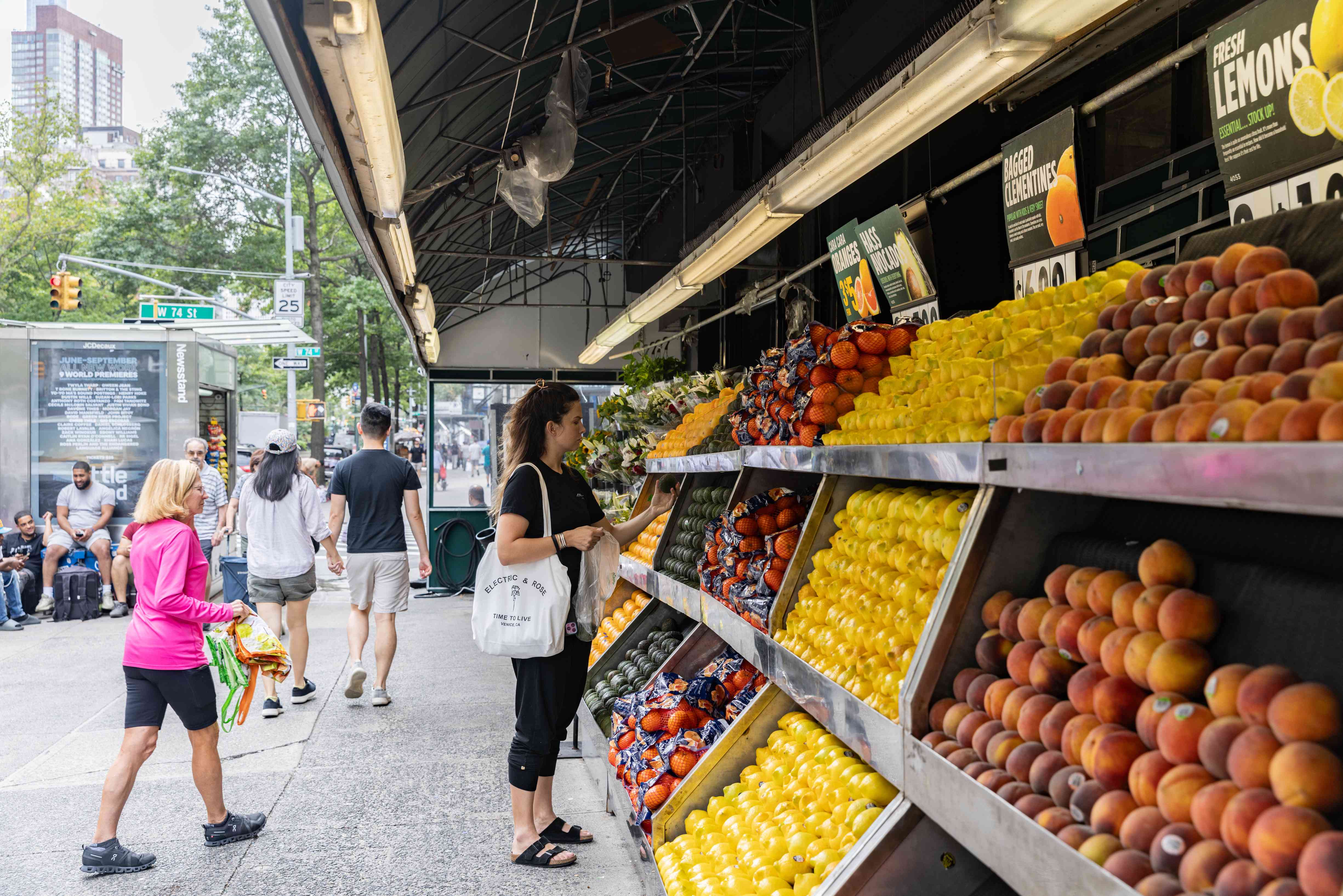 A shopper selects an avocado at a grocery store in New York on Aug. 29, 2024