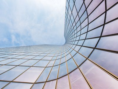 Curved skyscraper against blue sky