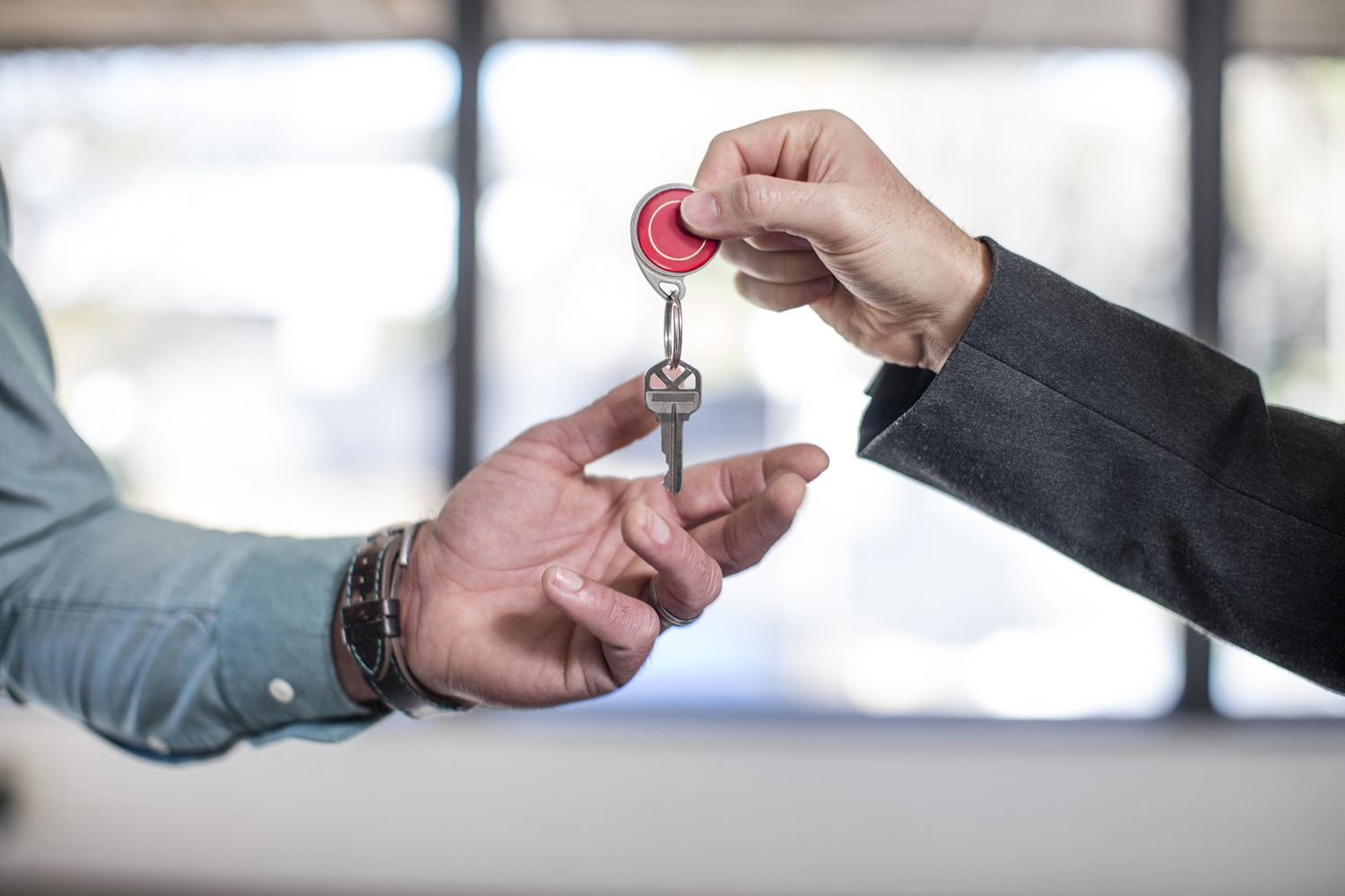 Estate Agent Handing Keys to Homebuyer