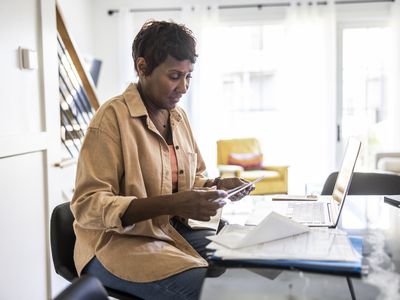 Senior woman applying for mortage using her laptop at home