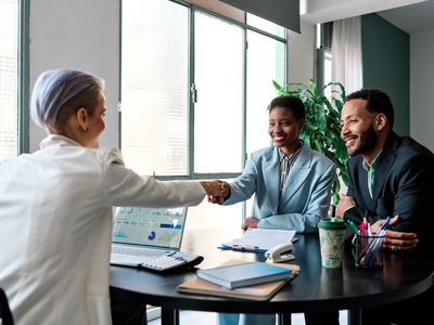 Businesswoman shaking hands to close a deal with clients in the office