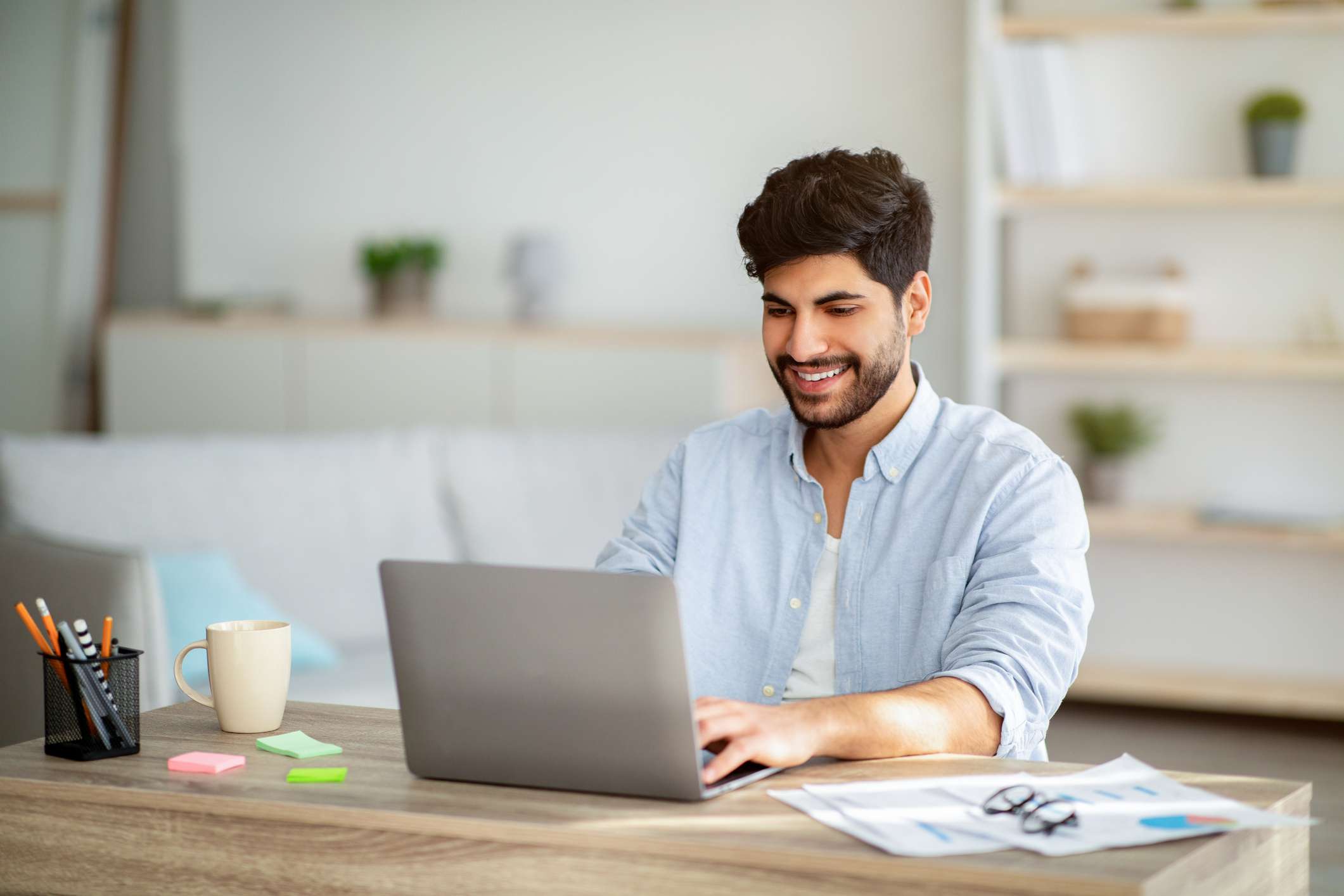 A man uses a laptop. 