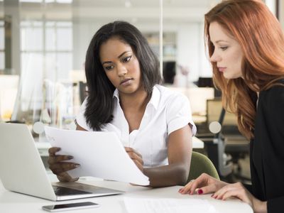 Two colleagues discussing loans on the purchase mortgage market