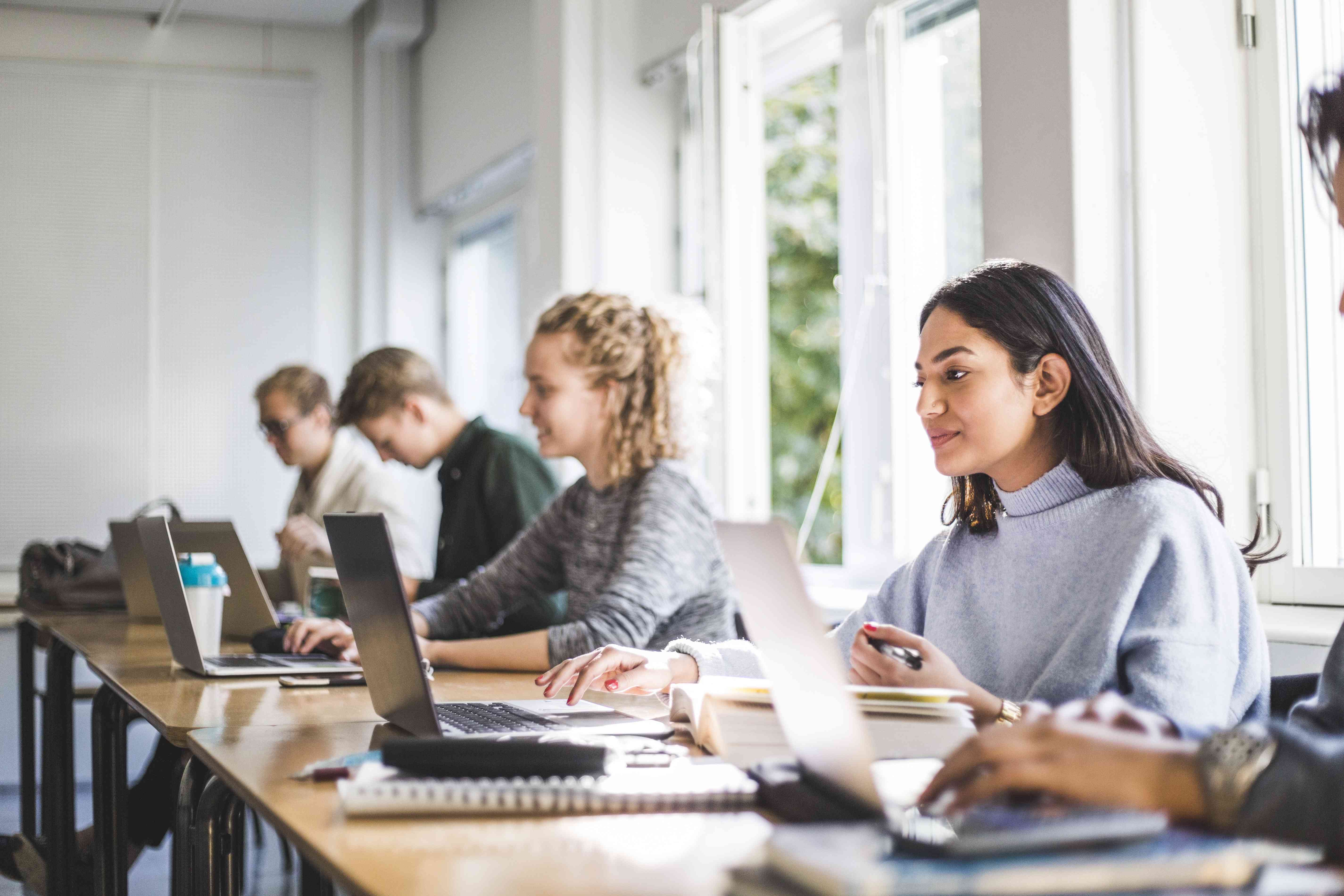 Students using laptops in classroom