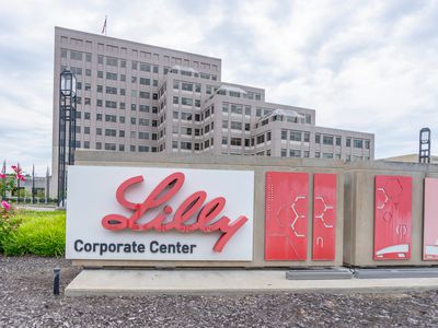 A sign for the Eli Lilly Corporate Center is seen outside a brown office building.