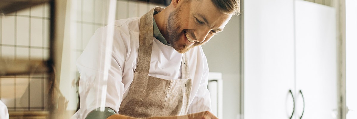 Chef in kitchen working on donuts