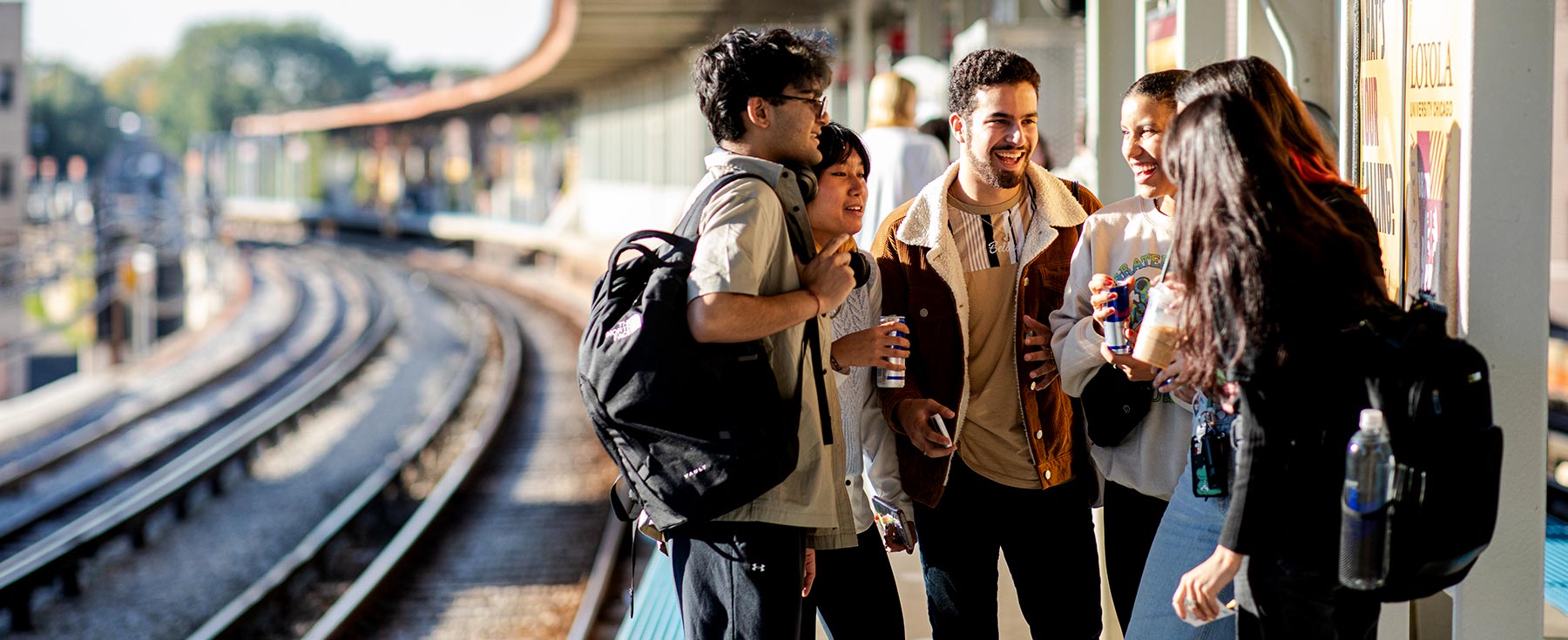 students standing on platform at Loyola red line stop