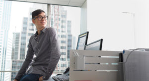 a person standing in front of a computer