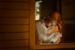 Photo of a contact center supervisor reading customer service data reports on tablet.