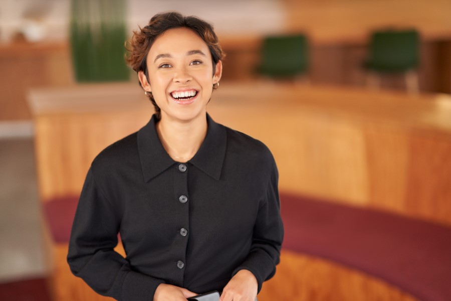 Portrait of a woman smiling, looking at the camera.