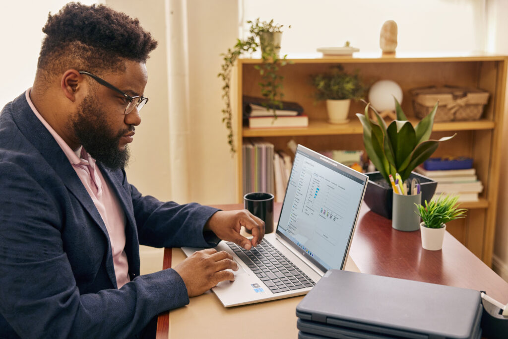 Person sitting at a desk working on their computer.