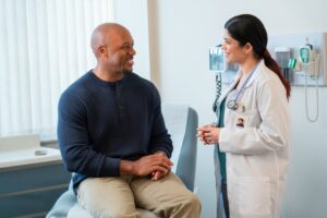 a doctor talking to a patient in the exam room.