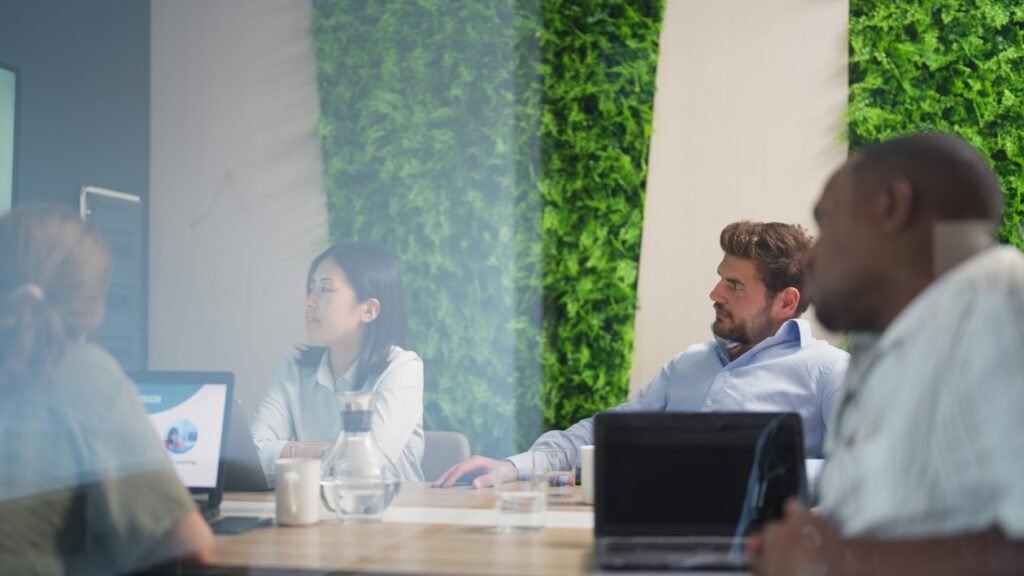 Group of business people are having a business meeting in a meeting room in a modern office working space.