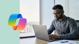 [3:38 PM] Jenn Sarfaty (Wipro Designit Services Inc) Executive sitting at desk using laptop in an office with a panoramic view. Including Copilot logo.