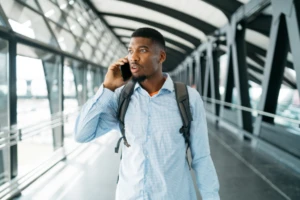 A man on the phone looking in the distance.