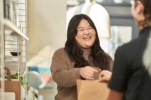 Retail customer picking up order in-store and checking out with customer service.