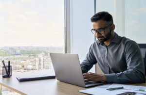 A financial professional working on a laptop