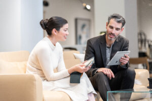 A store Associate shows a customer product offerings using a Surface Pro and D365 Supply Chain Management.