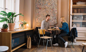 Image of a couple looking over a purchase on a mobile device.