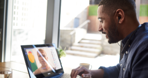 A remote worker in a Teams meeting on his laptop.