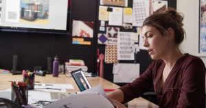 a woman at her desk with a laptop