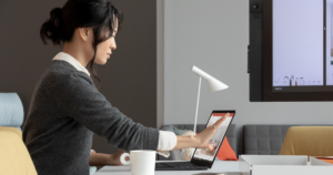 An image of a female tech worker using a laptop.