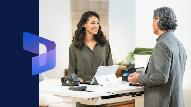 a man and a woman standing in front of a computer