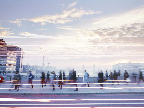 Business people walking through the city at dawn.